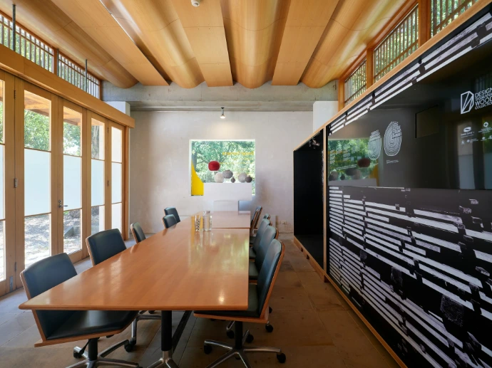 Modern conference room with long wooden table and chairs